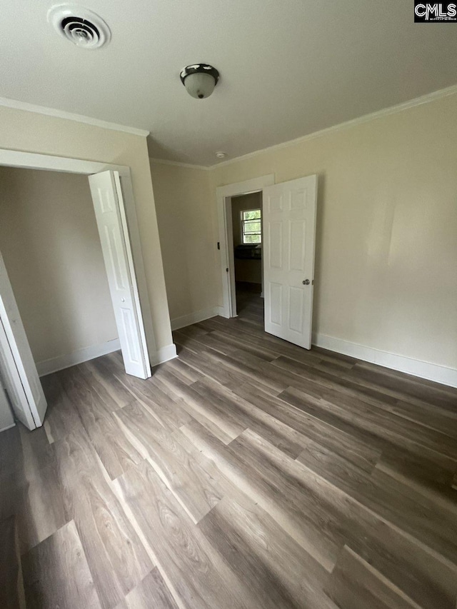 2803 Stewart St, Camden, SC 29020 - unfurnished bedroom featuring crown molding, wood finished floors, baseboards, and a closet