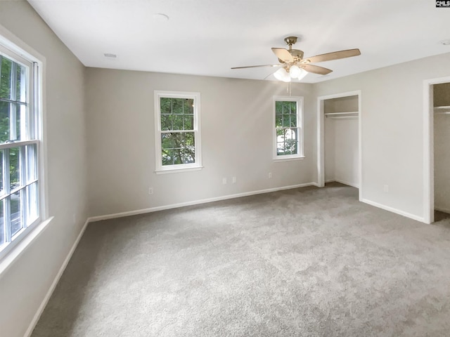 109 Hedgefield Rd, Irmo, SC 29063 - unfurnished bedroom featuring multiple windows, baseboards, carpet, and multiple closets