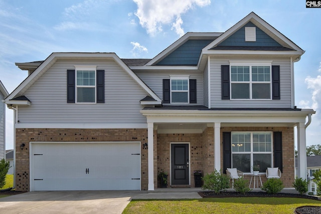 121 Bridgeport Rd, Elgin, SC 29045 - view of front of home featuring brick siding, covered porch, concrete driveway, and an attached garage