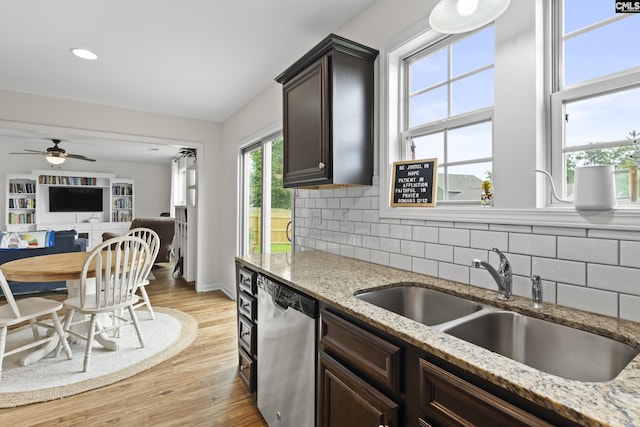150 Ventnor Ave, Chapin, SC 29036 - kitchen with stainless steel dishwasher, a sink, dark brown cabinetry, backsplash, and light wood-type flooring
