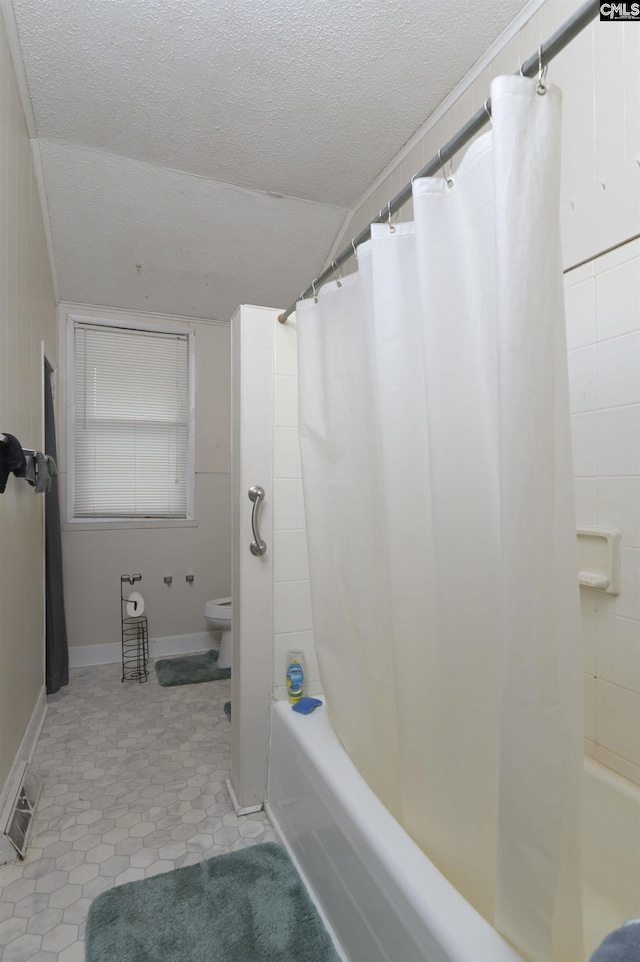 3334 Spring Dr, West Columbia, SC 29170 - bathroom featuring toilet, a textured ceiling, shower / tub combo with curtain, lofted ceiling, and tile patterned flooring