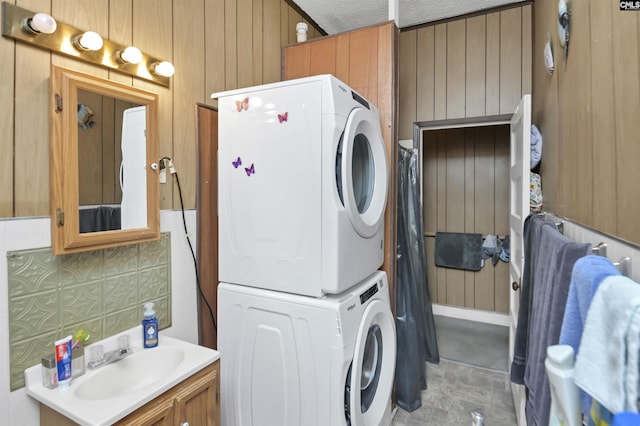 3334 Spring Dr, West Columbia, SC 29170 - washroom featuring stacked washing machine and dryer and wood walls