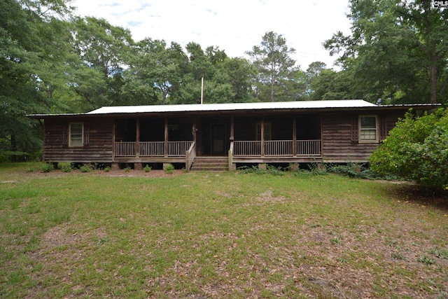 141 Frost Rd, Camden, SC 29020 - view of front of house with a front lawn, covered porch, metal roof, and view of wooded area