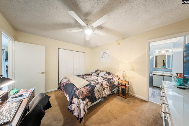 1211 Metze Rd Unit E6, Columbia, SC 29210 - bedroom with light carpet, a closet, baseboards, a ceiling fan, and a textured ceiling