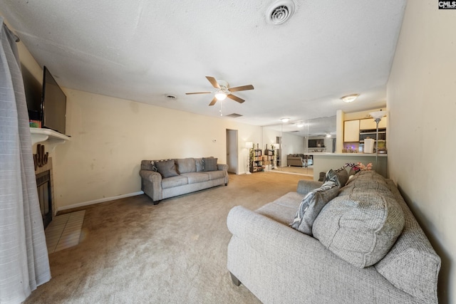 1211 Metze Rd Unit E6, Columbia, SC 29210 - living room featuring carpet floors, ceiling fan, a large fireplace, and baseboards