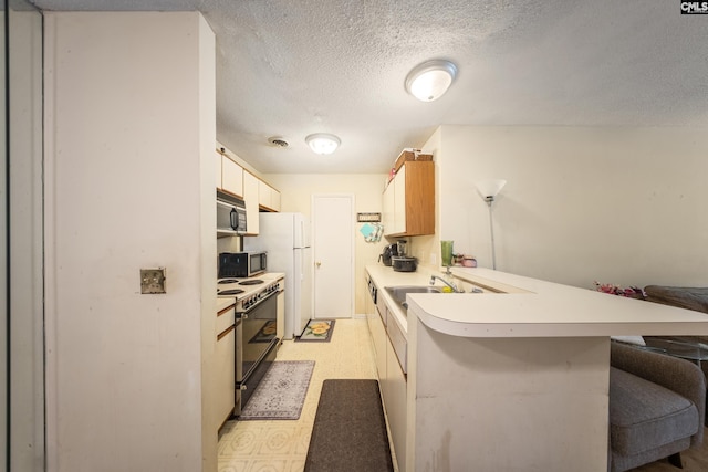 1211 Metze Rd Unit E6, Columbia, SC 29210 - kitchen featuring range with electric stovetop, a sink, light countertops, stainless steel microwave, and a peninsula