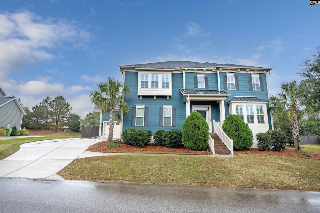 1064 Portrait Hill Dr, Chapin, SC 29036 - view of front of home with concrete driveway, a standing seam roof, a front lawn, and metal roof