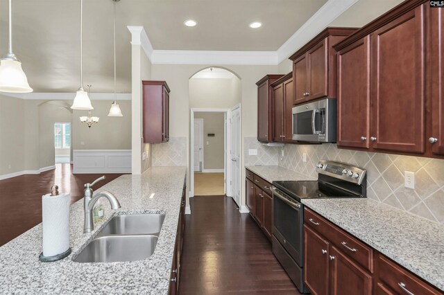 1 Downing Cir, Gilbert, SC 29054 - kitchen featuring stainless steel appliances, a sink, arched walkways, reddish brown cabinets, and light stone countertops