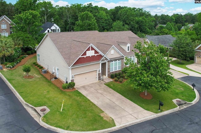 1 Downing Cir, Gilbert, SC 29054 - view of front of property featuring board and batten siding, concrete driveway, a garage, a front lawn, and central AC