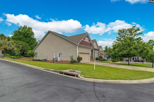 1 Downing Cir, Gilbert, SC 29054 - view of property exterior featuring board and batten siding, driveway, and a lawn