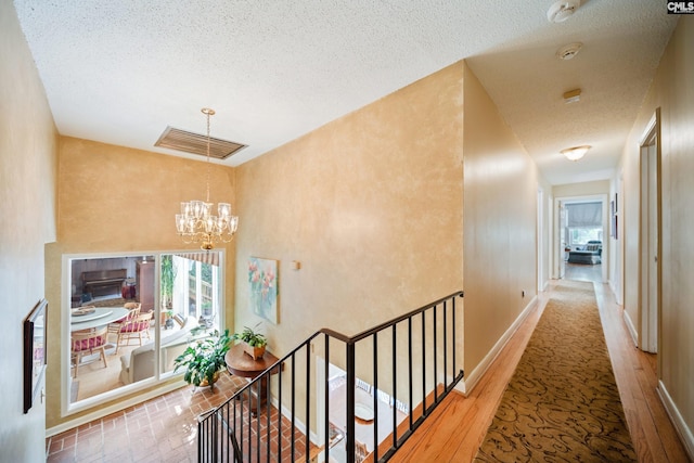3100 Grace Hill Rd, Columbia, SC 29204 - corridor with a chandelier, a textured ceiling, healthy amount of natural light, an upstairs landing, and baseboards