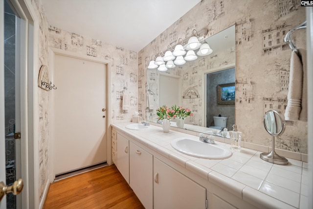 3100 Grace Hill Rd, Columbia, SC 29204 - bathroom featuring double vanity, wood finished floors, toilet, and wallpapered walls