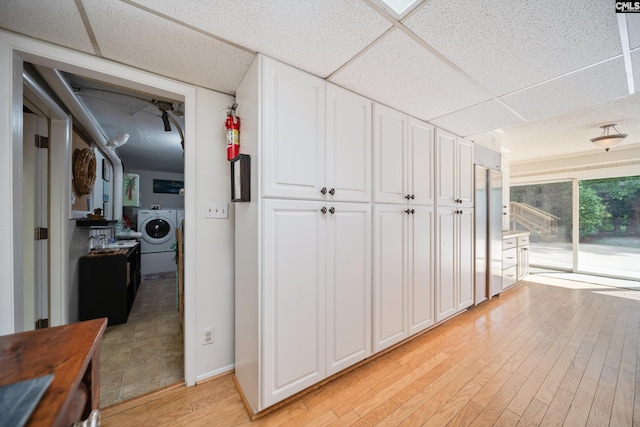 3100 Grace Hill Rd, Columbia, SC 29204 - hallway with washer / clothes dryer, a paneled ceiling, light wood-style floors, and baseboards