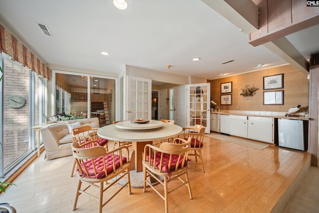 3100 Grace Hill Rd, Columbia, SC 29204 - dining space with french doors, light wood finished floors, healthy amount of natural light, and wooden walls