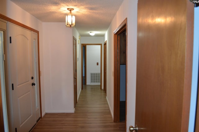 429 Kitti Wake Dr, West Columbia, SC 29170 - corridor with wood finished floors, a textured ceiling, and baseboards