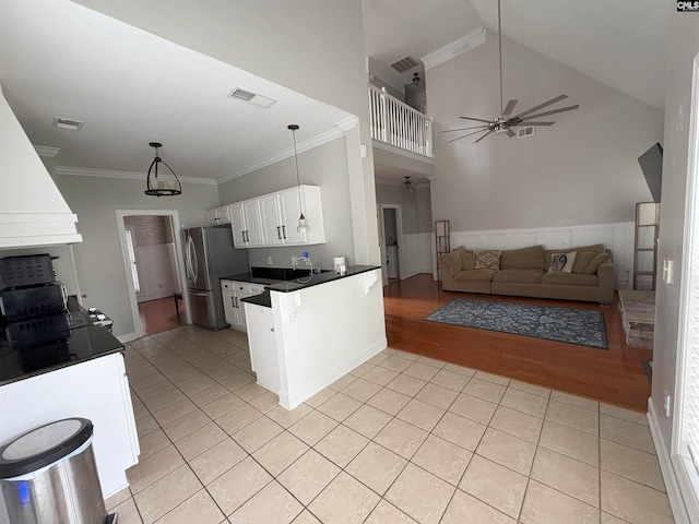 26 Peyton Rd, Columbia, SC 29209 - kitchen with freestanding refrigerator, dark countertops, ceiling fan, white cabinets, and ornamental molding
