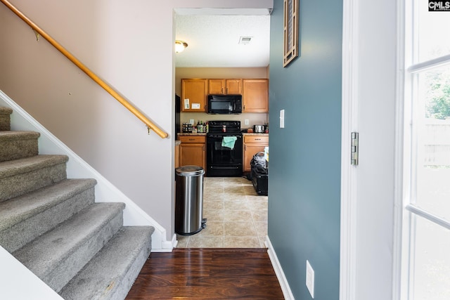 218 Blazer Dr, Lexington, SC 29073 - kitchen featuring black appliances, baseboards, and brown cabinetry