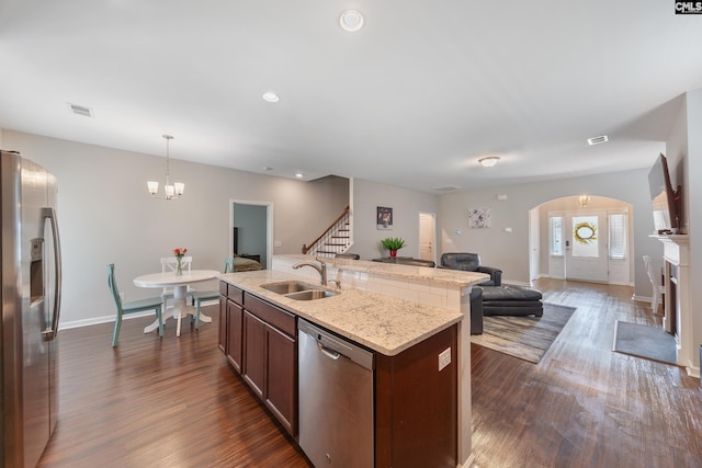 1148 Declaration Dr, Elgin, SC 29045 - kitchen with appliances with stainless steel finishes, a sink, arched walkways, open floor plan, and a center island with sink