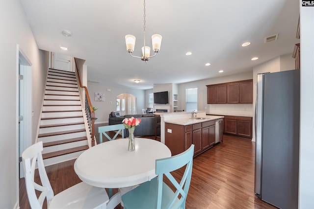 1148 Declaration Dr, Elgin, SC 29045 - dining space with dark wood-style flooring, stairway, a chandelier, recessed lighting, and arched walkways