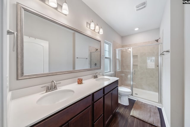 1148 Declaration Dr, Elgin, SC 29045 - full bath featuring a shower stall, toilet, double vanity, wood finished floors, and recessed lighting
