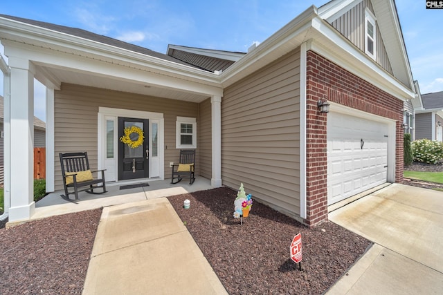 1148 Declaration Dr, Elgin, SC 29045 - view of exterior entry featuring brick siding, covered porch, a garage, and concrete driveway