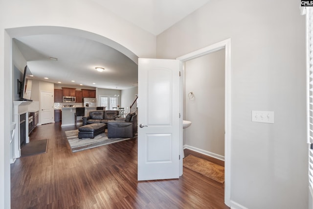 1148 Declaration Dr, Elgin, SC 29045 - living area featuring arched walkways, dark wood-type flooring, a fireplace, baseboards, and recessed lighting