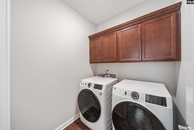 1148 Declaration Dr, Elgin, SC 29045 - washroom featuring washing machine and clothes dryer, cabinet space, baseboards, and dark wood-type flooring