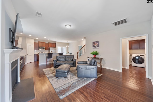 1148 Declaration Dr, Elgin, SC 29045 - living area featuring washer / dryer, stairs, dark wood-style floors, recessed lighting, and a fireplace