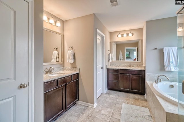 335 Hollow Cove Rd, Chapin, SC 29036 - bathroom with two vanities, a garden tub, baseboards, and tile patterned floors