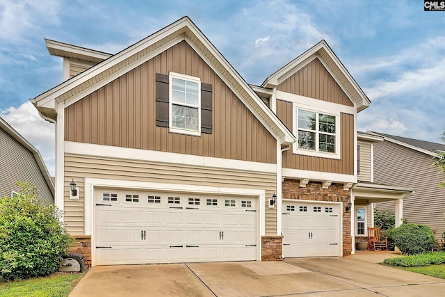 335 Hollow Cove Rd, Chapin, SC 29036 - view of front of property with stone siding, an attached garage, concrete driveway, and board and batten siding
