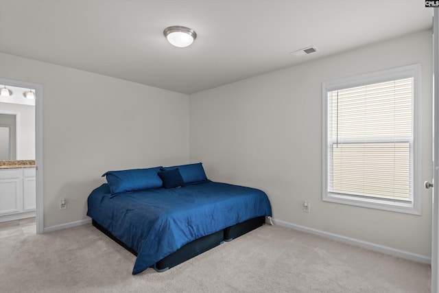 627 Cheehaw Ave, West Columbia, SC 29170 - bedroom featuring light colored carpet, baseboards, and ensuite bath