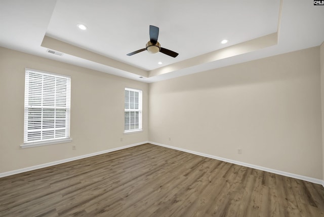 23 Ash Ct, Irmo, SC 29063 - empty room featuring a tray ceiling, wood finished floors, baseboards, a ceiling fan, and recessed lighting