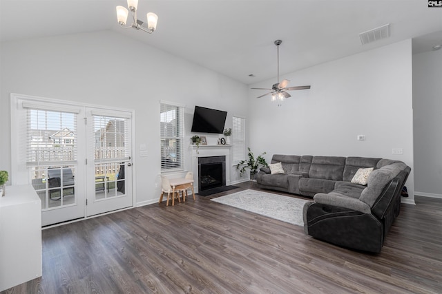1401 Ardennes Dr, Elgin, SC 29045 - living room featuring a fireplace with flush hearth, dark wood finished floors, high vaulted ceiling, a ceiling fan, and a chandelier