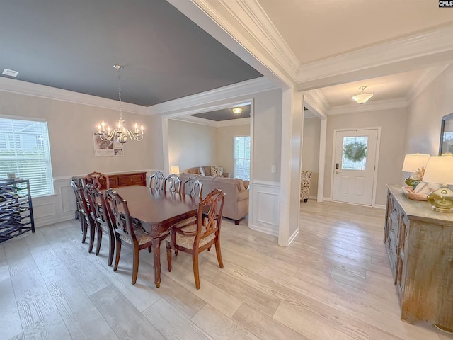 121 Ashford Way, Lexington, SC 29072 - dining space featuring a decorative wall, light wood-style floors, a wainscoted wall, a chandelier, and ornamental molding