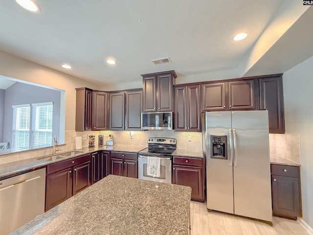 121 Ashford Way, Lexington, SC 29072 - kitchen featuring stainless steel appliances, a sink, decorative backsplash, light stone countertops, and recessed lighting