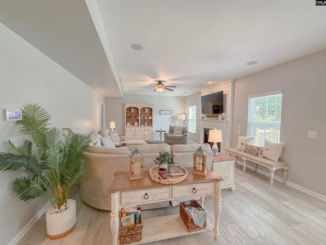 121 Ashford Way, Lexington, SC 29072 - living area featuring a ceiling fan, baseboards, light wood-style floors, and a fireplace