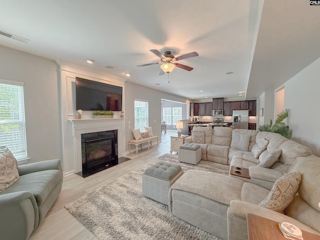 121 Ashford Way, Lexington, SC 29072 - living room with plenty of natural light, a ceiling fan, a fireplace with flush hearth, light wood-type flooring, and recessed lighting