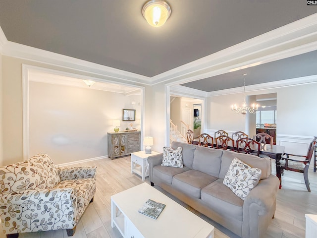 121 Ashford Way, Lexington, SC 29072 - living area featuring a chandelier, light wood finished floors, ornamental molding, stairway, and wainscoting