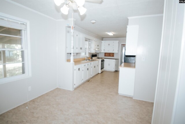 5199 Bethune Rd, Kershaw, SC 29067 - kitchen featuring white range with electric stovetop, crown molding, white cabinetry, ceiling fan, and light countertops