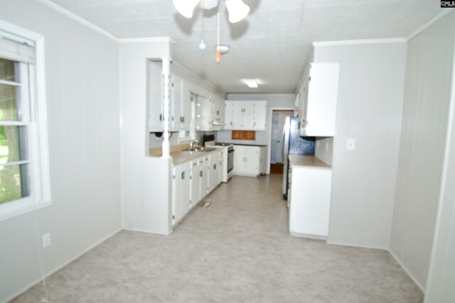 5199 Bethune Rd, Kershaw, SC 29067 - kitchen with range with electric cooktop, ornamental molding, white cabinets, ceiling fan, and a sink