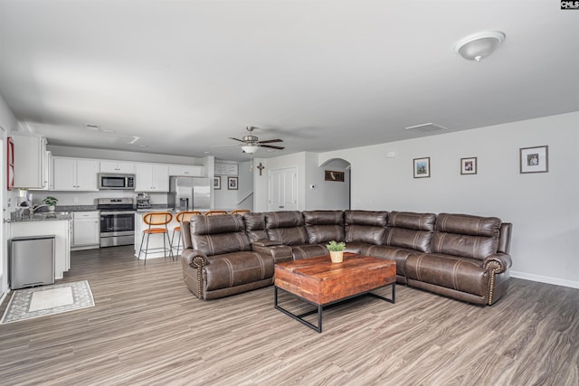 646 Penfolds Way, Blythewood, SC 29016 - living room featuring a ceiling fan, light wood finished floors, arched walkways, and baseboards
