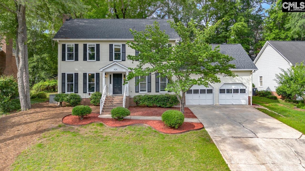 424 Winding Way, Columbia, SC 29212 - colonial inspired home with concrete driveway, a garage, a chimney, roof with shingles, and a front yard