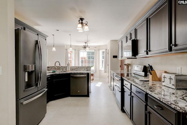 220 Pine Grove Rd, Lugoff, SC 29078 - kitchen with stainless steel appliances, a peninsula, a sink, and light stone countertops