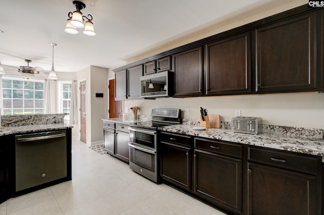 220 Pine Grove Rd, Lugoff, SC 29078 - kitchen featuring appliances with stainless steel finishes, light stone countertops, dark brown cabinets, and baseboards