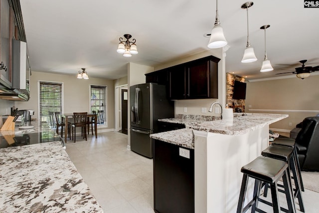 220 Pine Grove Rd, Lugoff, SC 29078 - kitchen featuring stainless steel fridge with ice dispenser, ceiling fan, a kitchen breakfast bar, light stone counters, and a peninsula