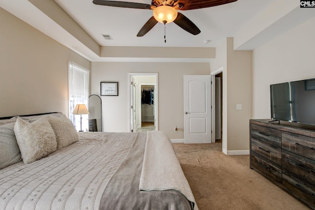 220 Pine Grove Rd, Lugoff, SC 29078 - bedroom featuring light carpet, a walk in closet, baseboards, and ceiling fan