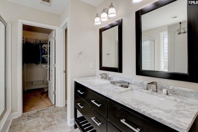 220 Pine Grove Rd, Lugoff, SC 29078 - full bathroom with a walk in closet, double vanity, baseboards, and a shower with shower door