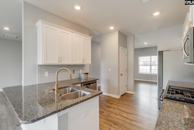 724 Channing Creek Ln, Lexington, SC 29072 - kitchen with a sink, white cabinetry, dark stone countertops, light wood-type flooring, and recessed lighting