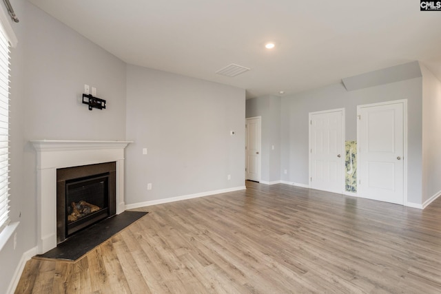 724 Channing Creek Ln, Lexington, SC 29072 - unfurnished living room with a glass covered fireplace, wood finished floors, baseboards, and recessed lighting