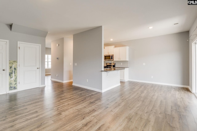 724 Channing Creek Ln, Lexington, SC 29072 - unfurnished living room featuring light wood-style flooring, baseboards, and recessed lighting